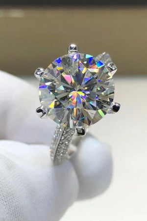 Silver pavé band moissanite solitaire ring with a round brilliant cut center stone.