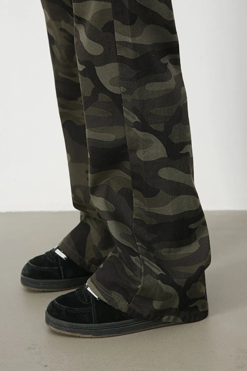 Camo flare denim trousers in green camouflage pattern.
