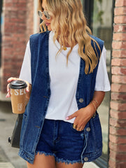 Oversized denim vest in medium blue with patch pockets and button front.