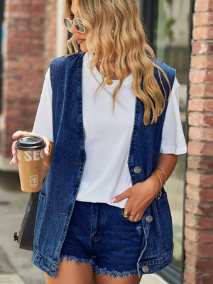 Oversized denim vest in medium blue with patch pockets and button front.