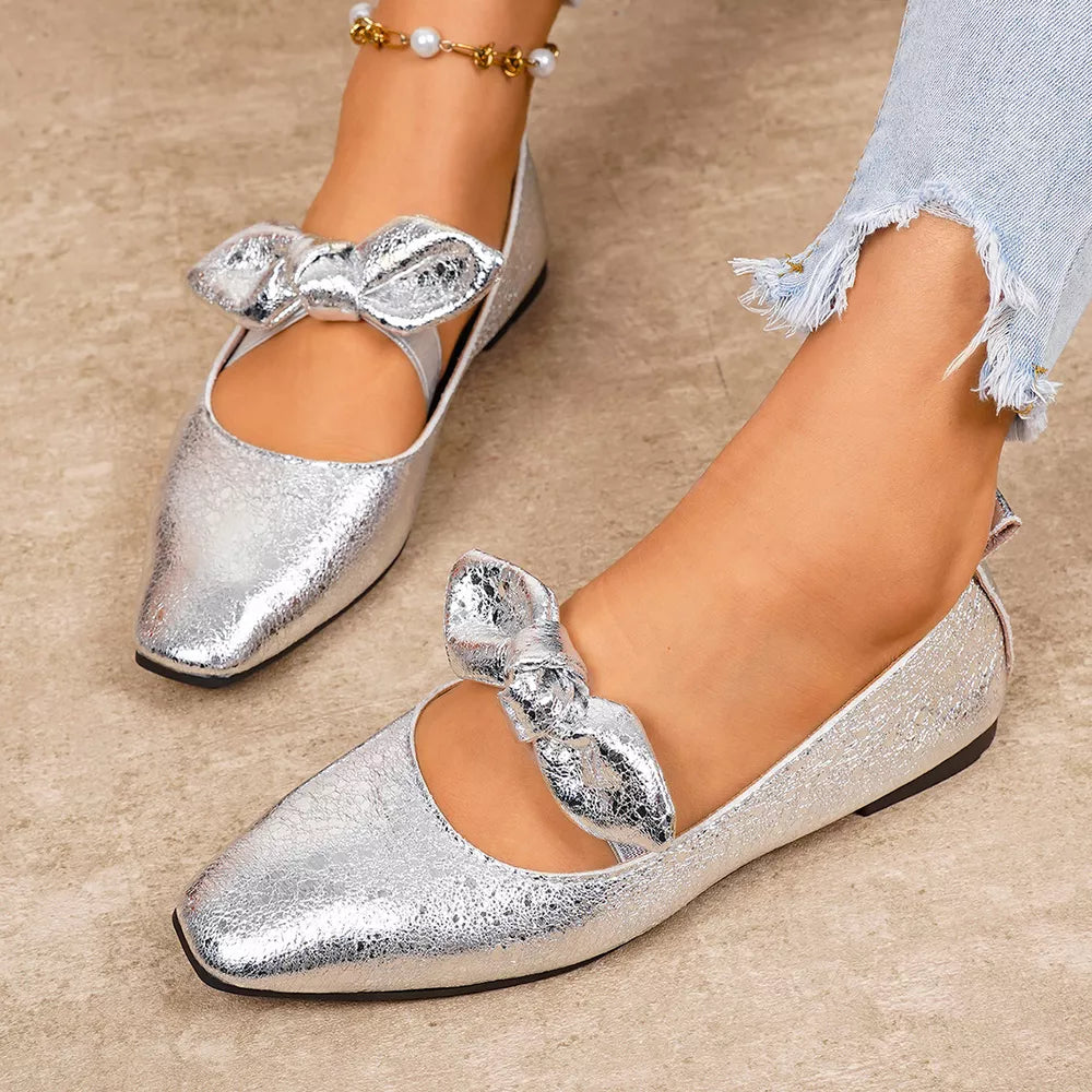 Chic silver slip-on flats with square toe and bow detail.
