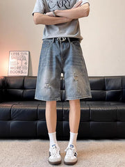 Men's distressed wide leg denim shorts in blue, made of 100% cotton.