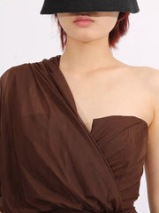 Brown draped one-shoulder maxi dress with sheer fabric and ruched bodice detail.