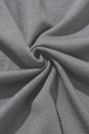 Gray wrap-front palazzo pants with slit hem, showing breathable fabric detail.