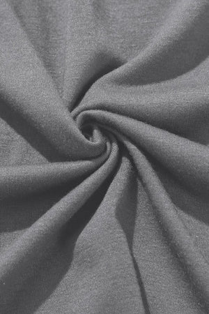 Gray wrap-front palazzo pants with slit hem, showing breathable fabric detail.