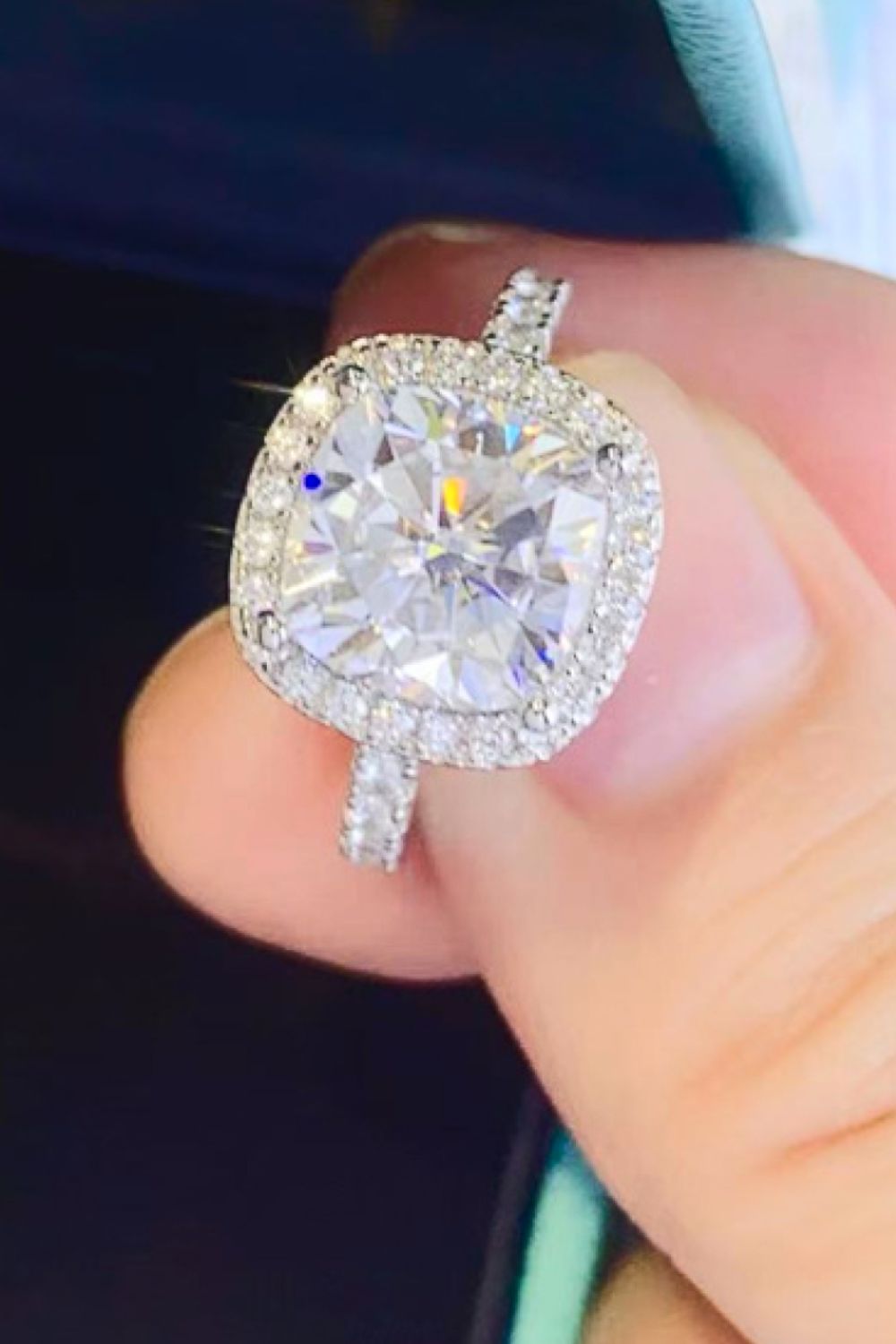 White cushion-cut halo engagement ring with diamond band