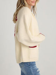 Cream knit cardigan with red lobster appliqué detail and contrast trim pockets.