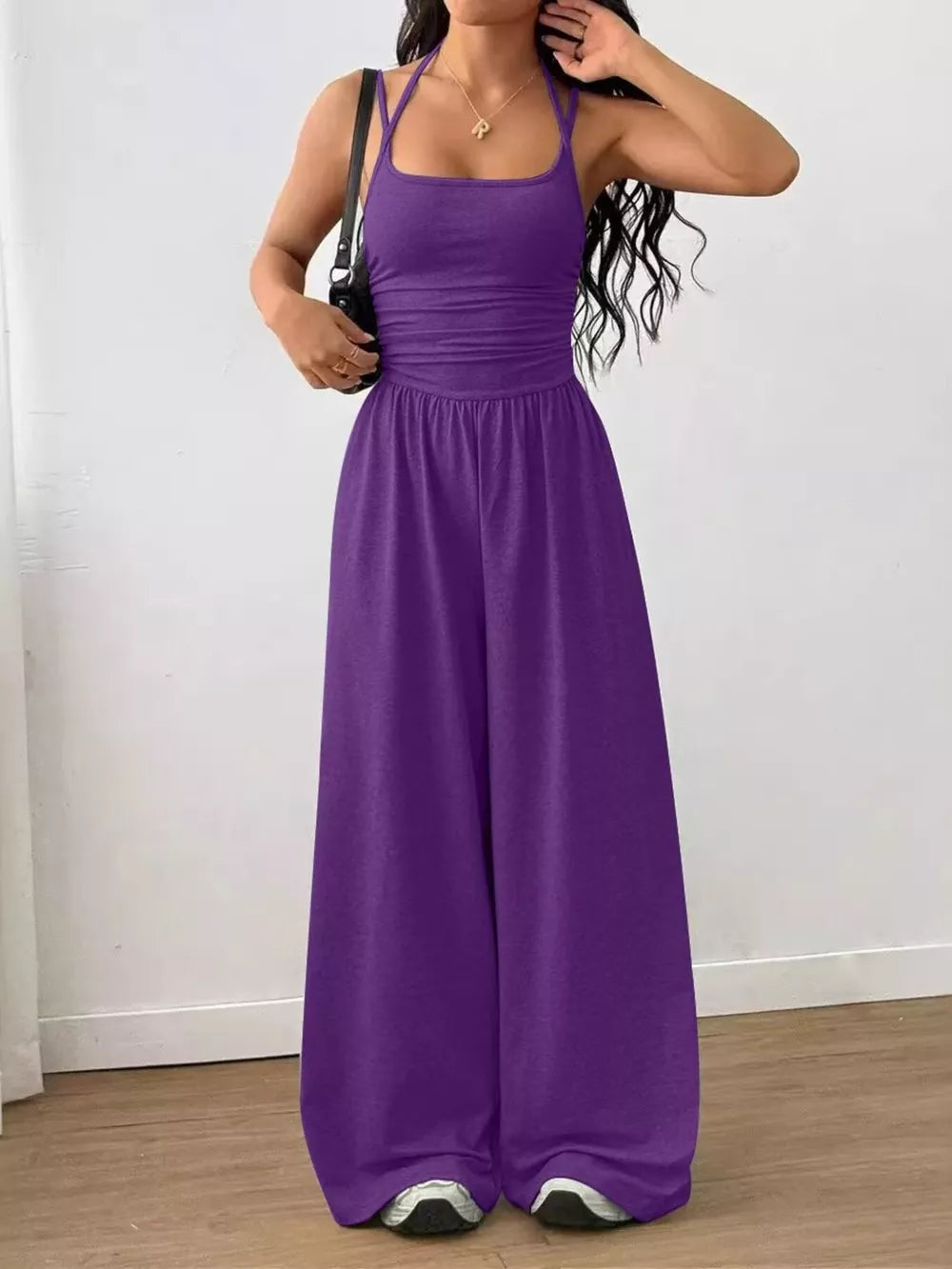Purple ruched wide-leg jumpsuit with spaghetti straps and a comfortable fit.
