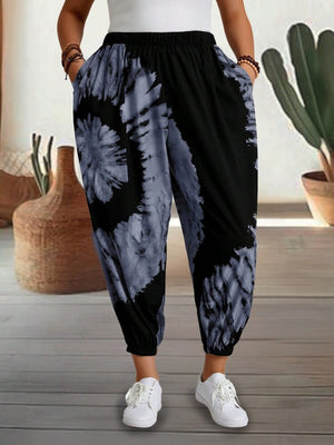 Tie-dye harem trousers with elastic waist and pockets, black and grey pattern.