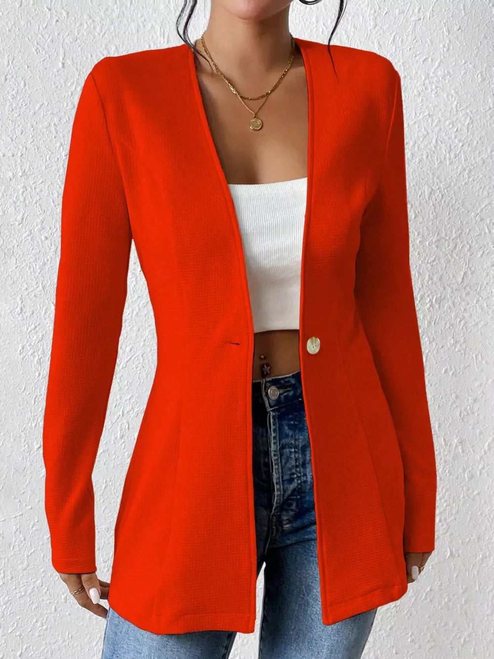 Red single-button blazer with tailored fit and textured fabric.