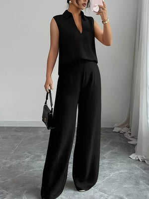 Black sleeveless collared V-neck top and wide-leg pants set with textured fabric.