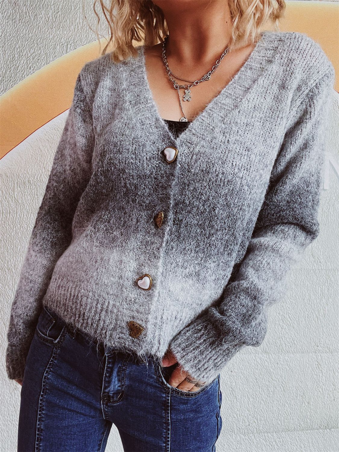 Gray ombre knit cardigan with heart buttons and V-neck.