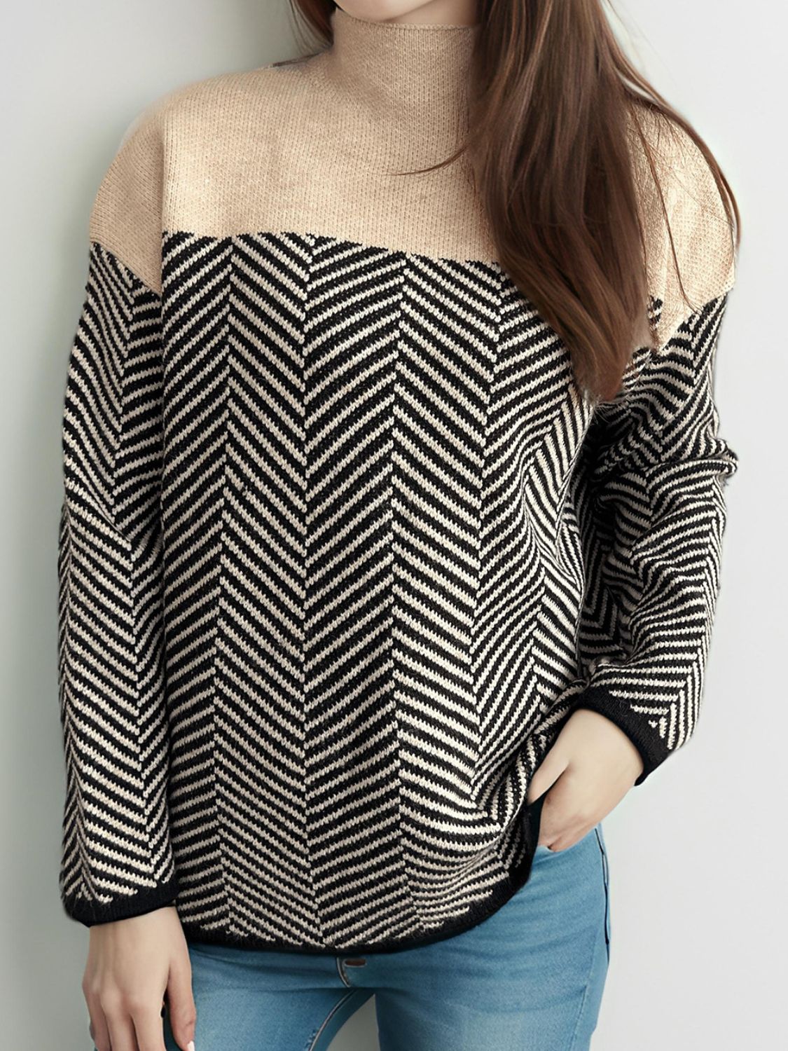 Chevron knit turtleneck sweater in black and tan with beige neckline.