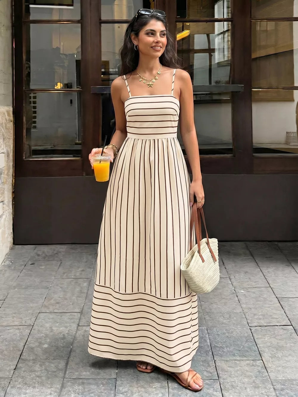 Striped maxi dress with smocked detail and cutout, in apricot and brown.