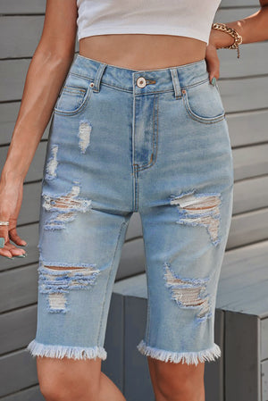 Light wash distressed denim bermuda shorts with frayed hem