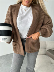 Textured puff sleeve cardigan in mocha with open front and pockets.