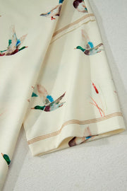Beige pajama set with mallard duck print and contrast stitching detail.