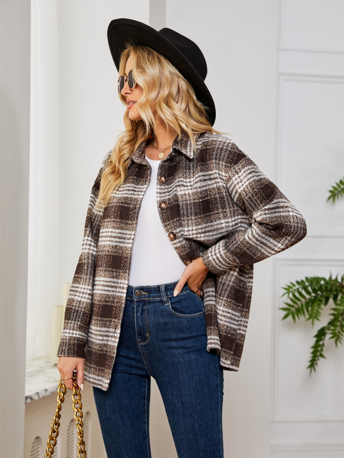 Brown plaid shacket with oversized button detail and collared neckline.