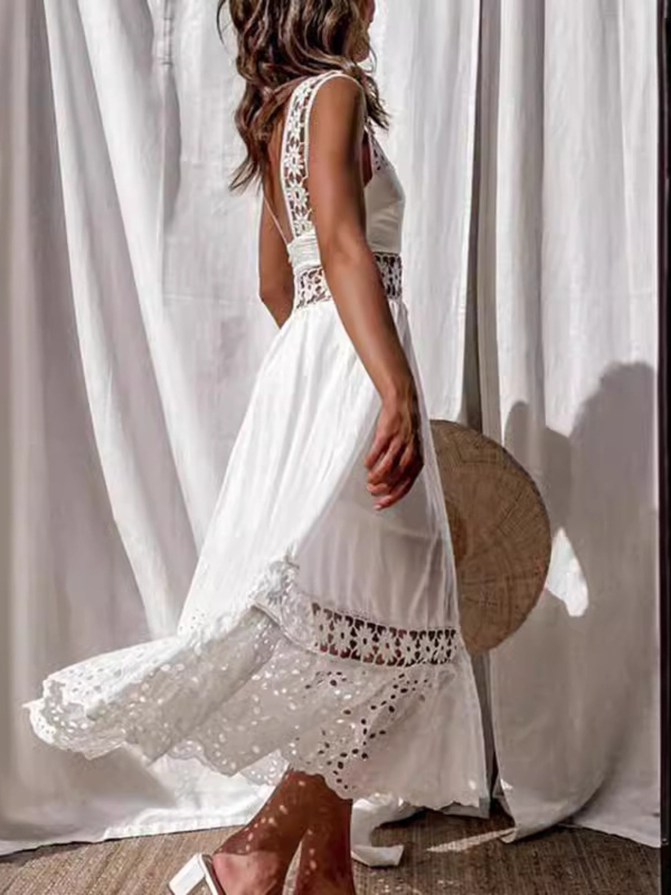 White openwork crochet sleeveless midi dress with cutout details and lace trim.