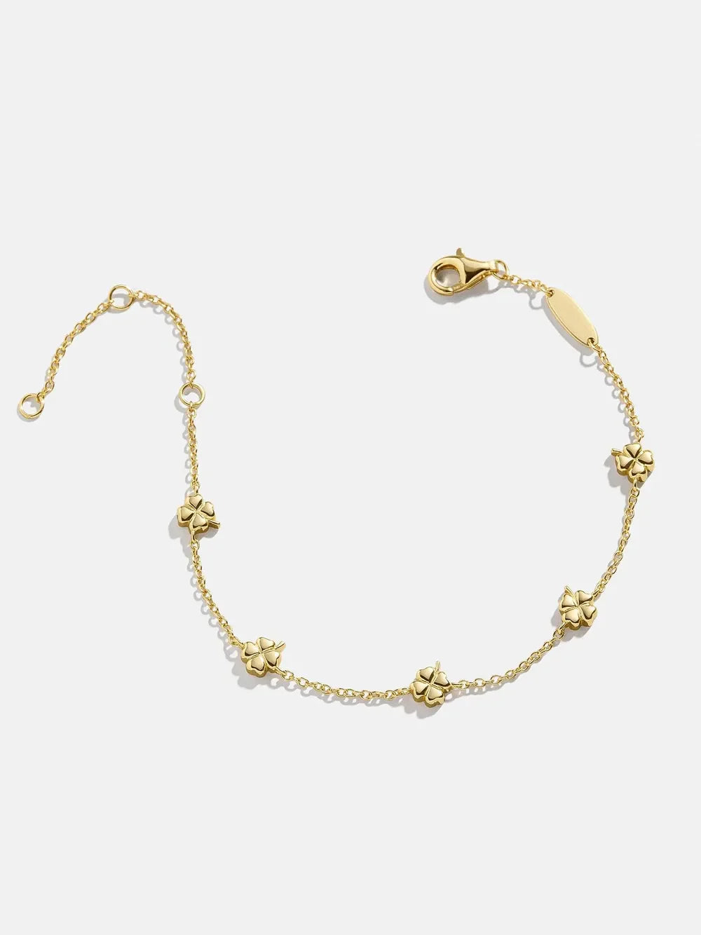 Gold chain bracelet with small four-leaf clover charms.