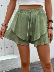 Tiered gauze drawstring shorts in matcha green with ruffled hem.