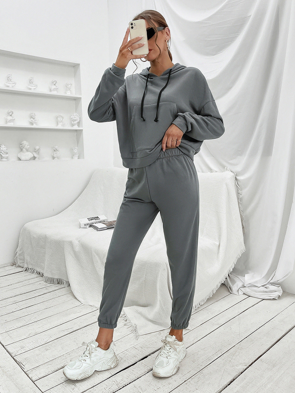 Dark gray cropped hoodie with front pocket and drawstring joggers.