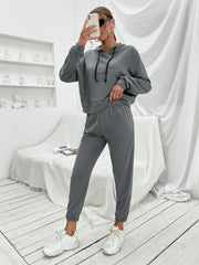 Dark gray cropped hoodie with front pocket and drawstring joggers.