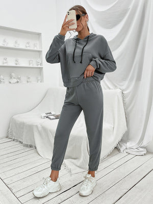 Dark gray cropped hoodie with front pocket and drawstring joggers.