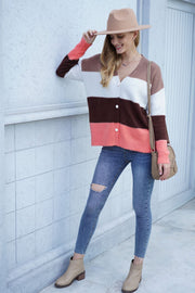 Colorblock acrylic cardigan with metallic trim in orange, brown, white and pink stripes.
