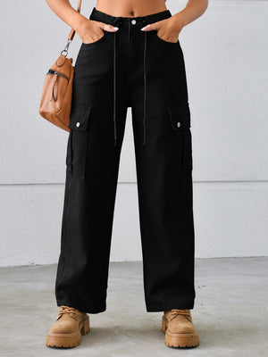 Black denim cargo wide-leg trousers with drawstring waist and buttoned flap pockets.