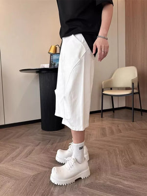 Relaxed white cargo cropped pants with unique pocket detail.
