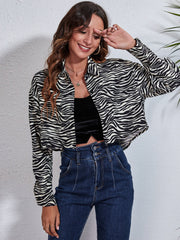 Checkerboard cropped shirt jacket in zebra print with button front and collar.
