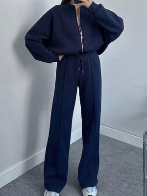 Dark blue zip-up hoodie and drawstring pants set with front seams.