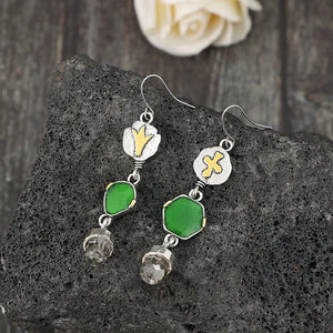 Geometric emerald drop earrings with silver hooks and clear crystal accents.