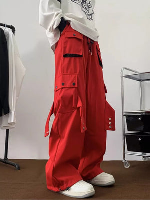 Red relaxed-fit cargo pants with multiple pockets and adjustable ankle straps.