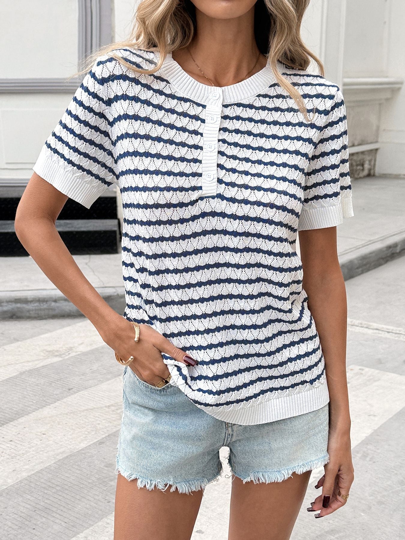 Chic striped knit top with button placket and short sleeves.