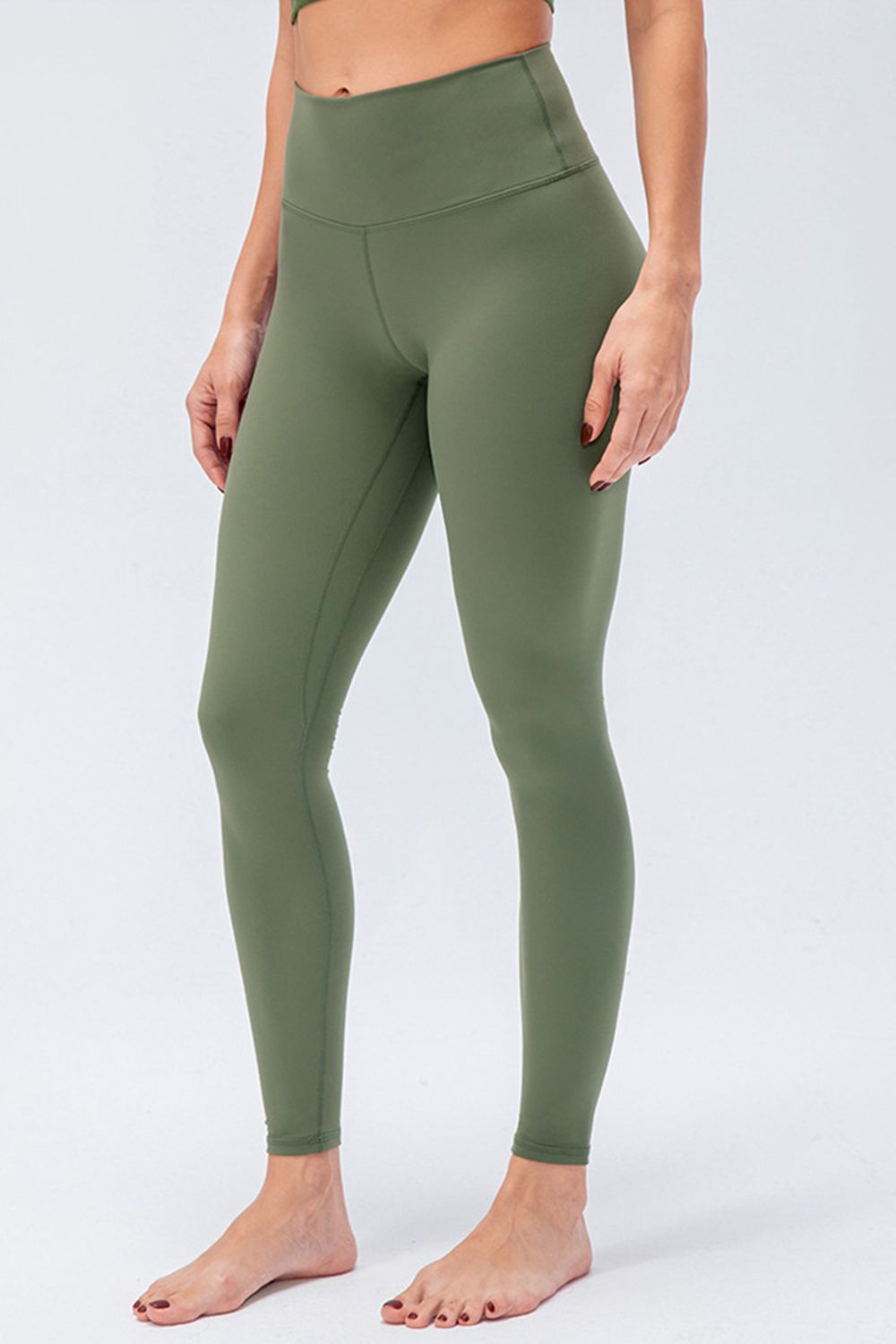 Sculpted olive high-rise performance leggings with a seamless waistband and full length.