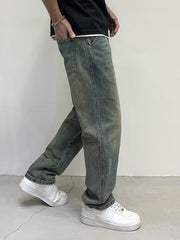 Men's loose-fit jeans in blue-green wash with distressed details and cotton fabric.