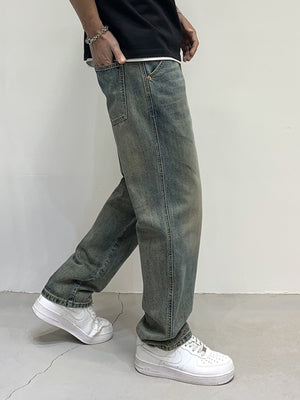 Men's loose-fit jeans in blue-green wash with distressed details and cotton fabric.