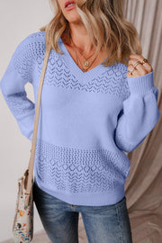 Light blue perforated knit v-neck sweater with openwork details on the yoke and hem.
