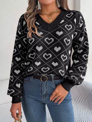 Black acrylic v-neck sweater with white heart jacquard pattern and long sleeves