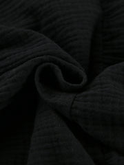 Black cotton tiered mini dress with textured fabric detail