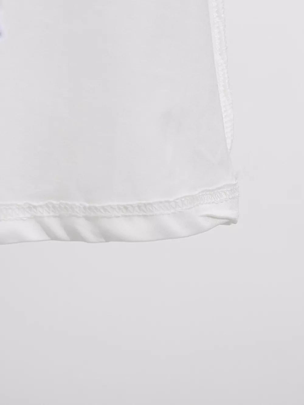 White midi dress detail showing hem and stitching