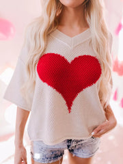 Beige V-neck knit sweater with large red heart pattern, short sleeves, and casual fit.