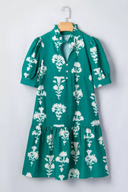 Green floral mini dress with puff sleeves, ruffled collar, and tiered hem.