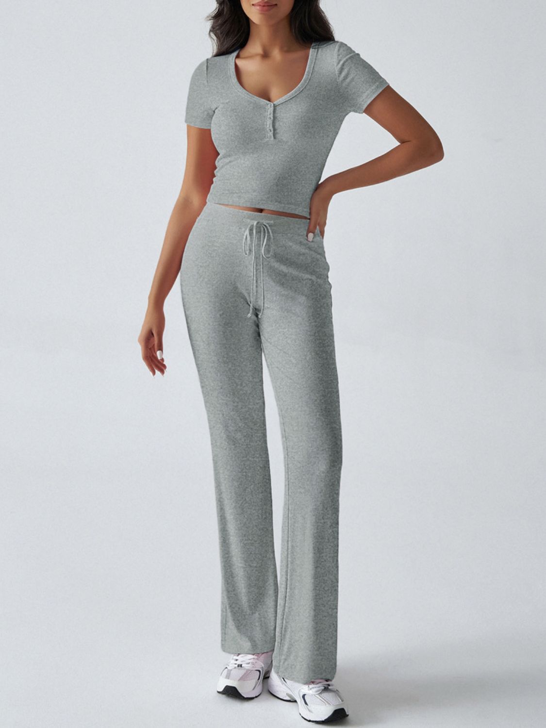 Light gray button-front crop top and flared lounge pants with drawstring waist.