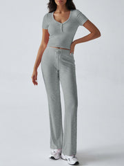 Light gray button-front crop top and flared lounge pants with drawstring waist.