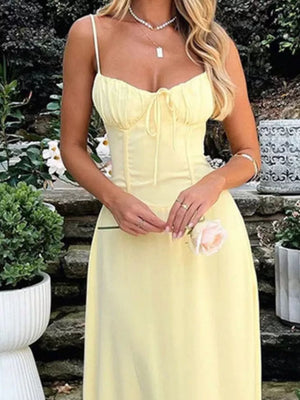 Pastel yellow tie-front maxi dress with spaghetti straps and a cinched waist detail.