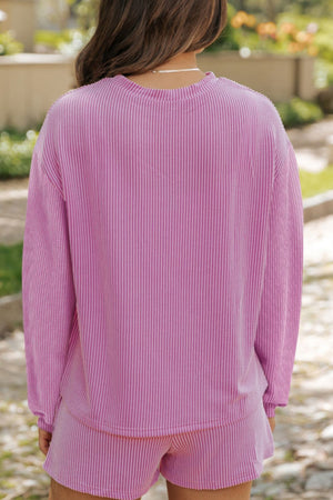 Ribbed fuchsia pink loungewear set with crew neck long sleeve top and shorts.