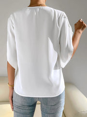 White polyester blouse with cape sleeves and lace trim detail.